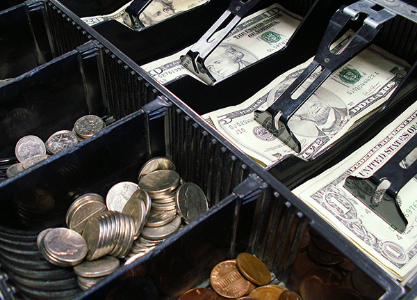 Cash register drawer with bills and coins